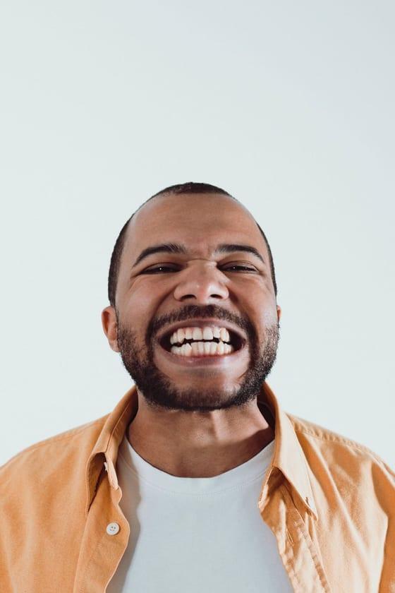 Passport photo example with an open-mouth expression