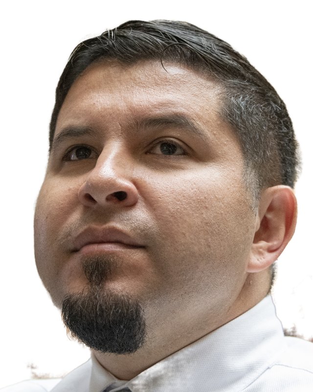 Man with short hair and a goatee in a tight frontal headshot
