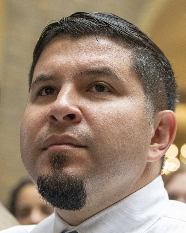 Man with short hair and a goatee in a tight frontal headshot