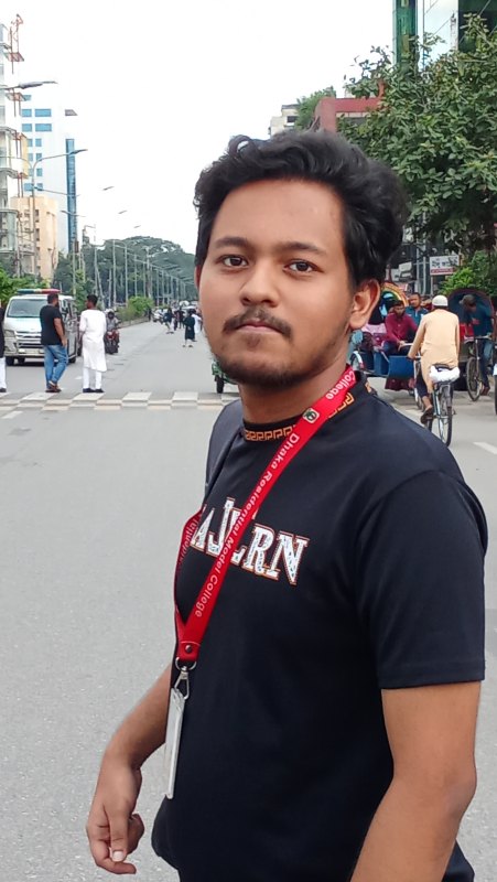 Young man with short hair photographed on a city street