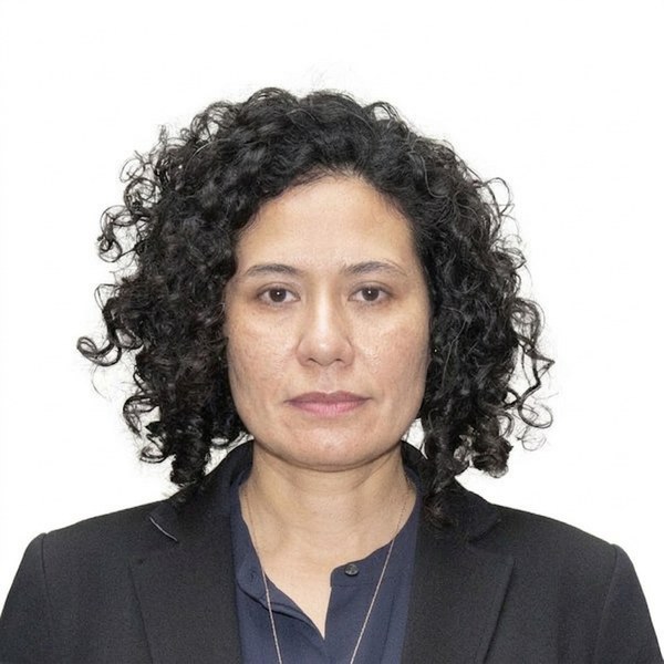 Woman with curly dark hair in a frontal headshot — AI উন্নত
